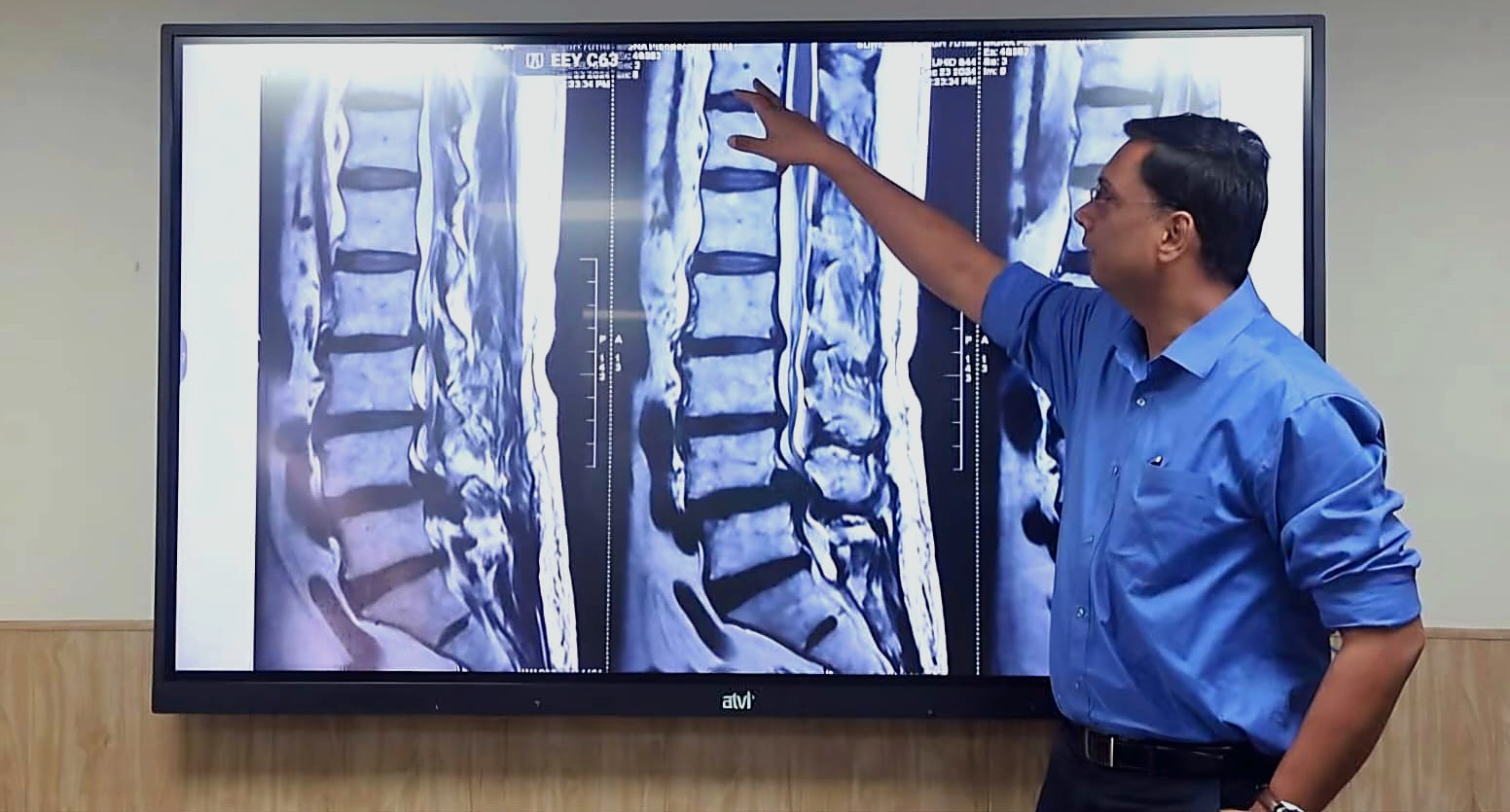 Dr. Navneet Agarwal reviewing a lumbar spine MRI in clinic
